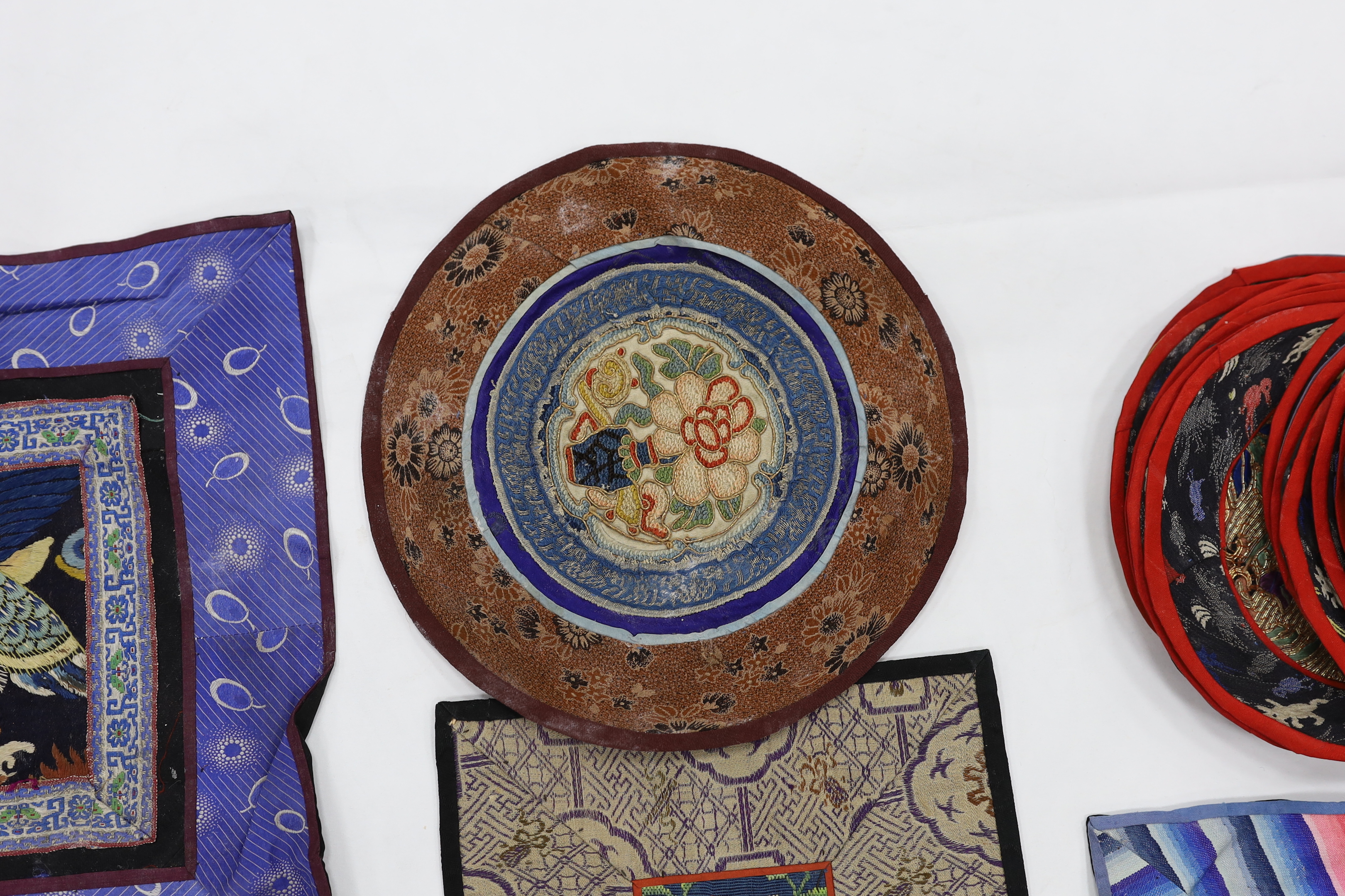 A Kesi Chinese woven panel, a Beijing knot mat, two other embroidered panels, a circular mat together with two sets of six circular mats with gold thread embroidery of animals